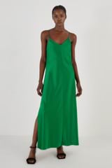 Profile view of model wearing the Oroton Fluid Satin Slip Dress in Kelly Green and 80% Acetate, 20% Polyester for Women