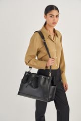 Profile view of model wearing the Oroton Harvey Baby Bag And Mat in Black and Smooth Leather for Women