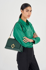 Profile view of model wearing the Oroton Alexa Medium Satchel in Juniper and Nappa Leather for Women