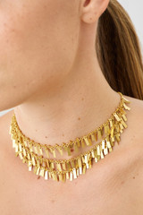Profile view of model wearing the Oroton Vera Necklace in Worn Gold and Brass for Women