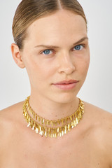 Profile view of model wearing the Oroton Vera Necklace in Worn Gold and Brass for Women