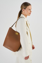 Profile view of model wearing the Oroton Kerr Hobo in Brandy and Smooth Leather for Women