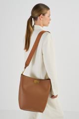 Profile view of model wearing the Oroton Kerr Hobo in Brandy and Smooth Leather for Women