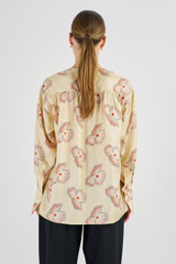 Profile view of model wearing the Oroton Spaced Floral Blouse in Cream and 100% Silk for Women