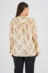 Profile view of model wearing the Oroton Spaced Floral Blouse in Cream and 100% Silk for Women