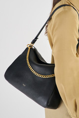 Profile view of model wearing the Oroton Asha Medium Hobo in Black and Pebble Leather for Women