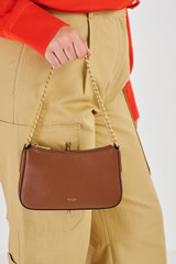 Profile view of model wearing the Oroton Asha Baguette Crossbody in Whiskey and Pebble Leather for Women