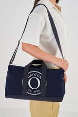 Profile view of model wearing the Oroton Kane Carry All in Navy and Recycled Canvas for Women