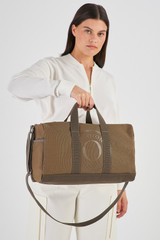 Profile view of model wearing the Oroton Kane Carry All in Khaki and Recycled Canvas for Women