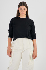 Profile view of model wearing the Oroton Contrast Trim Crew Neck in Black and 100% Merino Wool for Women