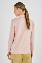 Profile view of model wearing the Oroton Merino 3/4 Sleeve Polo in Iced Pink and 100% Merino Wool for Women