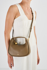 Profile view of model wearing the Oroton Clara Mini Bag in Willow and Pebble Leather for Women