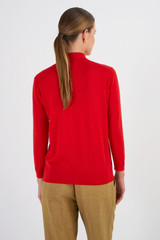 Profile view of model wearing the Oroton Merino 3/4 Sleeve Polo in Poppy and 100% Merino Wool for Women