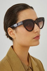 Profile view of model wearing the Oroton Sunglasses Dallas in Signature Tort and Acetate for Women