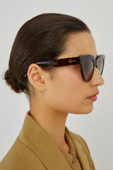 Profile view of model wearing the Oroton Sunglasses Dallas in Signature Tort and Acetate for Women