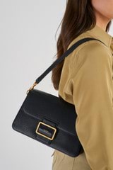 Profile view of model wearing the Oroton Astrid Shoulder Bag in Black and Pebble Leather for Women