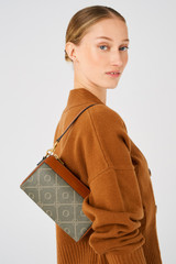 Profile view of model wearing the Oroton Harvey Signature Baguette Crossbody in Black/Cognac and Printed Coated Canvas With Leather Trims for Women