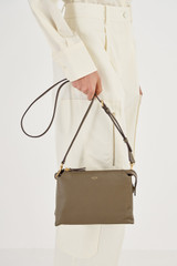 Profile view of model wearing the Oroton Sadie Crossbody in Olive and Pebble Leather for Women