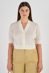 Profile view of model wearing the Oroton Short Sleeve Cropped Cardi in Cream and 100% Merino Wool for Women