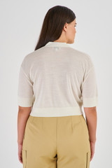 Profile view of model wearing the Oroton Short Sleeve Cropped Cardi in Cream and 100% Merino Wool for Women