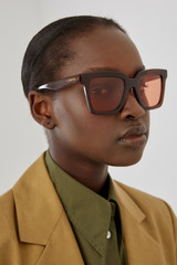Profile view of model wearing the Oroton Sunglasses Easton in Caramel and Acetate for Women