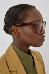 Profile view of model wearing the Oroton Sunglasses Easton in Caramel and Acetate for Women