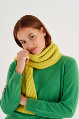 Profile view of model wearing the Oroton Woods Knit Scarf in Bright Chartreuse and 100% Merino Wool for Women