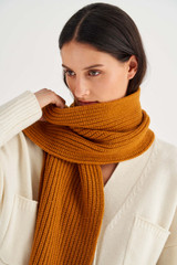 Profile view of model wearing the Oroton Woods Knit Scarf in Tan and 100% Merino Wool for Women