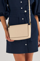 Profile view of model wearing the Oroton Polly Crossbody in Oatmeal and Pebble Leather for Women