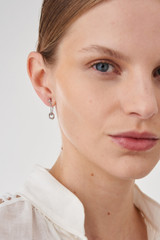 Profile view of model wearing the Oroton Wrenley Chain Studs in Silver and Brass Base Metal With Rhodium Plating for Women