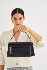 Profile view of model wearing the Oroton Perry Day Bag in Black and Smooth Leather for Women