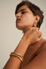Profile view of model wearing the Oroton Noa Earrings in Worn Gold and  for Women