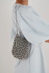Profile view of model wearing the Oroton Vera Luxe Bead Bag in Silver and Nickel Base Metal With Precious Metal Plating for Women