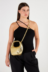 Profile view of model wearing the Oroton Tulip Metallic Mini Day Bag in Gold and Pebble Leather for Women