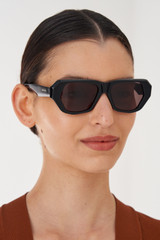 Profile view of model wearing the Oroton Quade Sunglasses in Black and Acetate for Women