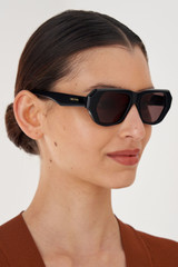 Profile view of model wearing the Oroton Quade Sunglasses in Black and Acetate for Women