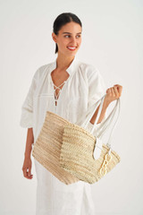 Profile view of model wearing the Oroton Madison Small Tote in White/Natural and Smooth Leather and Woven Straw for Women