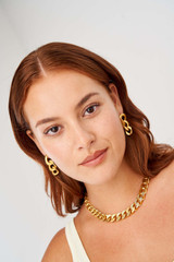 Profile view of model wearing the Oroton Noa Texture Earrings in Worn Gold and  for Women