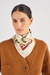 Profile view of model wearing the Oroton Alphabet Silk Scarf in Jute and 100% Silk for Women