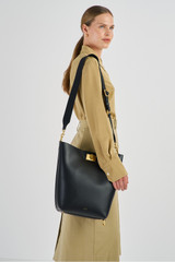 Profile view of model wearing the Oroton Kerr Hobo in Black and Smooth Leather for Women