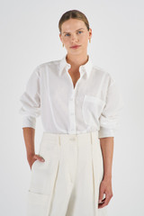 Profile view of model wearing the Oroton Bib Front Dinner Shirt in White and 100% Cotton for Women