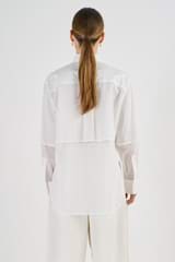 Profile view of model wearing the Oroton Bib Front Dinner Shirt in White and 100% Cotton for Women