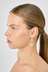 Profile view of model wearing the Oroton Marlee Triple Hoops in Worn Gold/White and Brass for Women