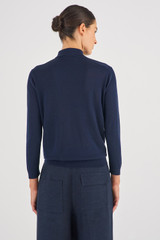 Profile view of model wearing the Oroton Merino 3/4 Sleeve Polo in North Sea and 100% Merino Wool for Women
