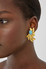 Profile view of model wearing the Oroton Tropea Clip On Earrings in Worn Gold/Turquoise and 18-karat gold plating for Women