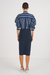 Profile view of model wearing the Oroton Milano Knit Pencil Skirt in North Sea and 83% Viscose 17 % Polyester for Women