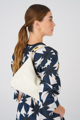Profile view of model wearing the Oroton North Hobo in Porcelain and Smooth leather for Women