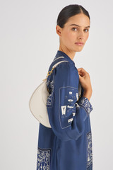Profile view of model wearing the Oroton Florence Small Shoulder Bag in Clotted Cream and Smooth leather for Women