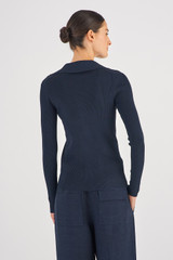 Profile view of model wearing the Oroton Long Sleeve Rib Henley in North Sea and 83% Viscose 17% Polyester for Women