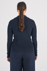 Profile view of model wearing the Oroton Long Sleeve Rib Henley in North Sea and 83% Viscose 17% Polyester for Women